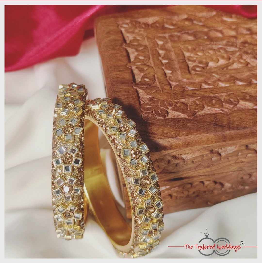 Floral-patterned lac-metal bangles in Kangan style, studded with elegant Kundan stones