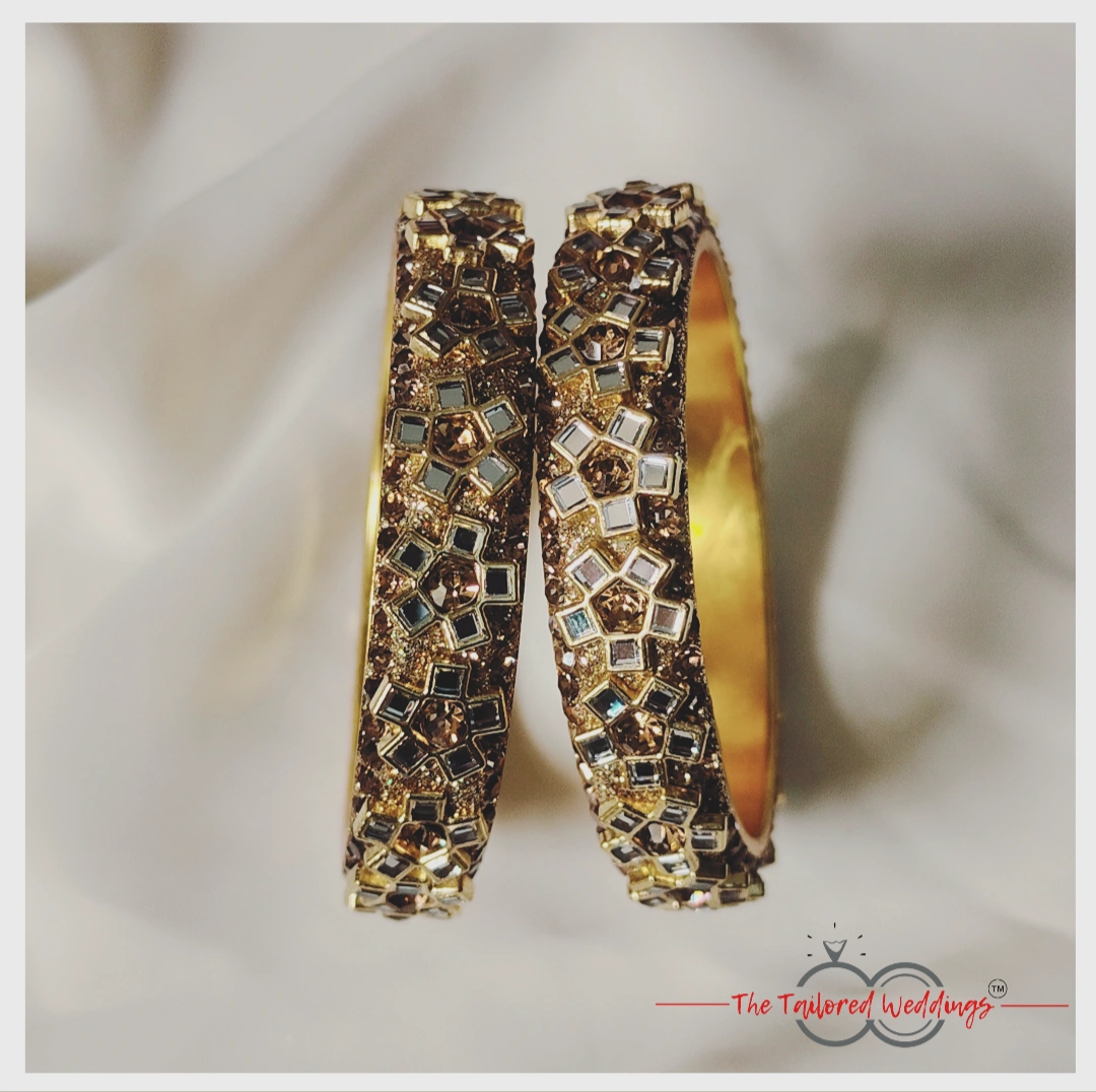 Floral-patterned lac-metal bangles in Kangan style, studded with elegant Kundan stones