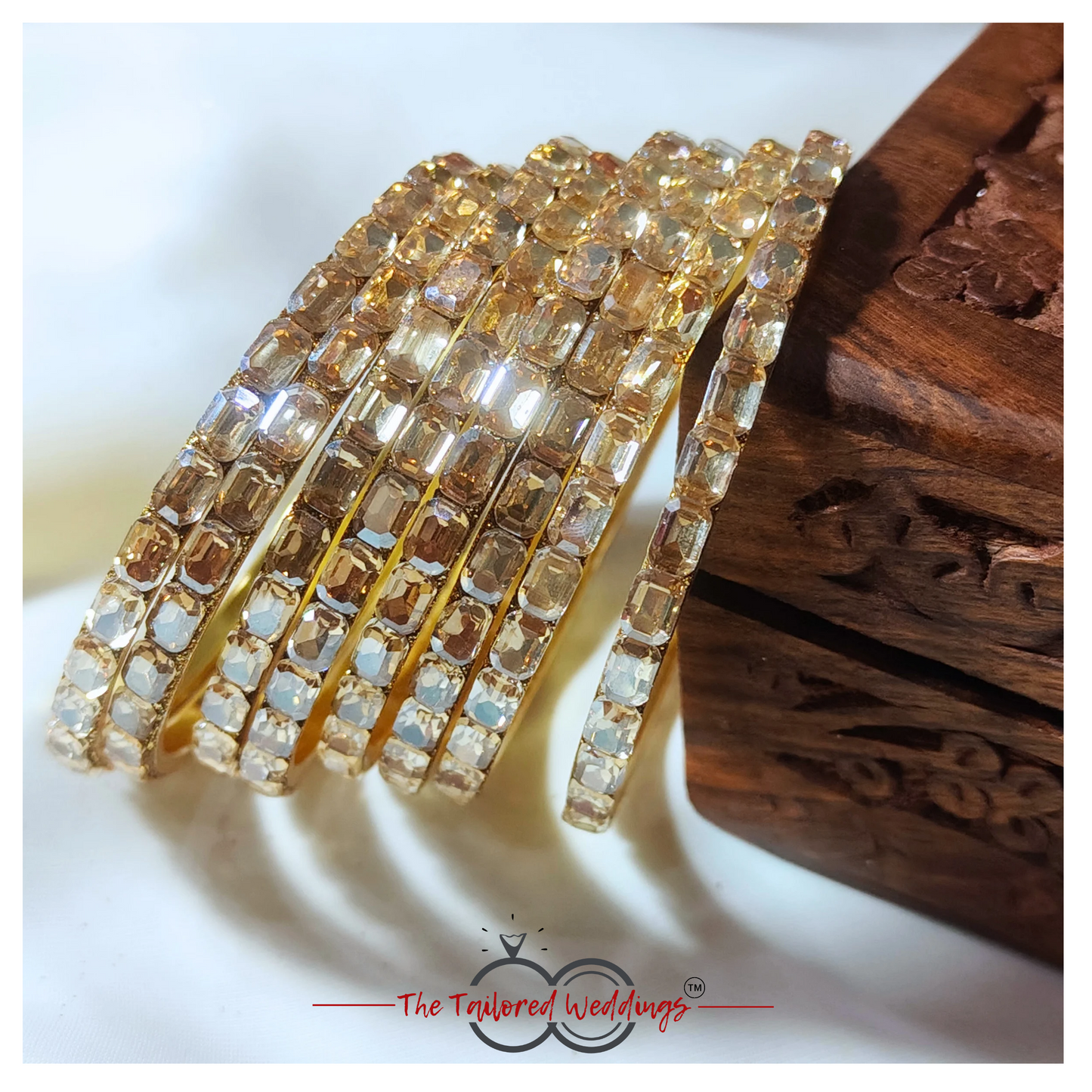 Gold-toned bangles crafted from a mix of lac and metal, studded with sparkling shadow stones
