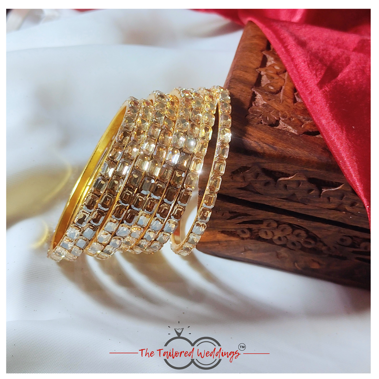 Gold-toned bangles crafted from a mix of lac and metal, studded with sparkling shadow stones