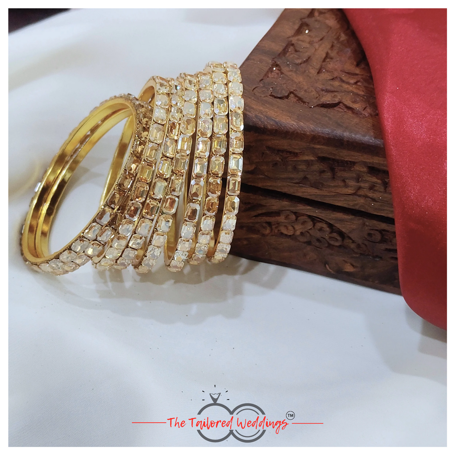 Gold-toned bangles crafted from a mix of lac and metal, studded with sparkling shadow stones