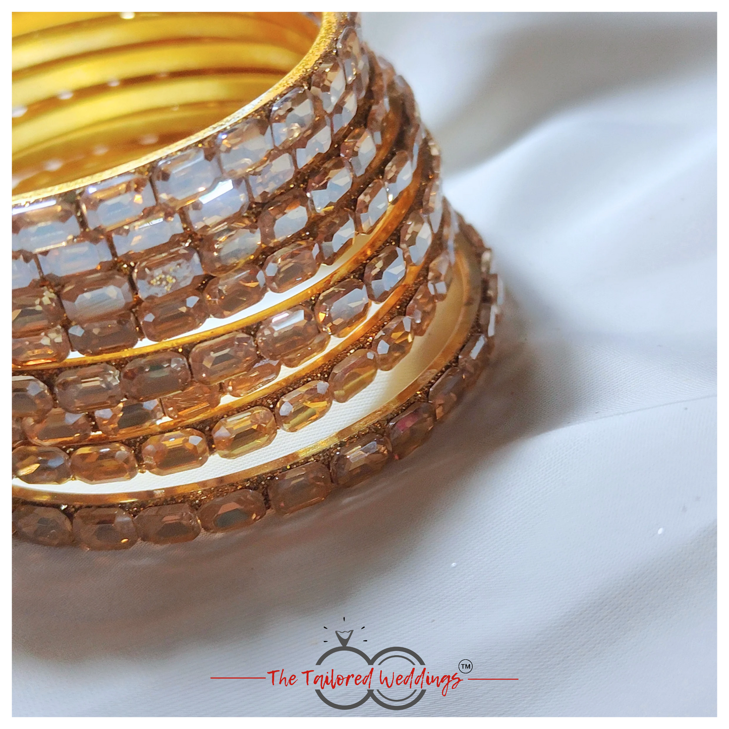 Gold-toned bangles crafted from a mix of lac and metal, studded with sparkling shadow stones